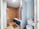 Bathroom boasts a unique, vintage clawfoot tub with brown tile surround, paired with modern toilet at 4708 Bugg Rd, Plant City, FL 33567
