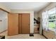 Spare room with sliding closet doors and window featuring patterned curtains at 4708 Bugg Rd, Plant City, FL 33567