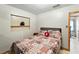 Inviting bedroom with a decorative pillow, open doorway, and ample light at 4708 Bugg Rd, Plant City, FL 33567