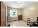 Bedroom with neutral walls, ironing board, wood cabinet and small writing desk at 4708 Bugg Rd, Plant City, FL 33567