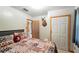Inviting bedroom with a decorative pillow, open doorway, closet, and ample closet space at 4708 Bugg Rd, Plant City, FL 33567