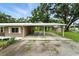 Exterior of the house with covered parking, well maintained yard, and additional storage at 4708 Bugg Rd, Plant City, FL 33567