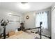Home exercise room with stationary bike, pull-down resistance system and decorative gray walls at 4708 Bugg Rd, Plant City, FL 33567
