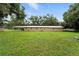 Exterior view of a single-story home with a well-manicured lawn and plenty of backyard space at 4708 Bugg Rd, Plant City, FL 33567