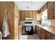 Kitchen featuring wood cabinets, an oven, and a refrigerator at 4708 Bugg Rd, Plant City, FL 33567