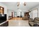 Open concept living room with a wood-burning stove, ceiling fan, and ceramic flooring at 4708 Bugg Rd, Plant City, FL 33567