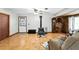 Inviting living room featuring wood floors, a wood-burning stove, and rustic wood accents at 4708 Bugg Rd, Plant City, FL 33567