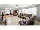 Open-concept living space with hardwood floors and a comfortable sectional sofa at 4708 Bugg Rd, Plant City, FL 33567