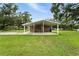 Covered patio featuring a neutral color, a concrete floor, and ample room for entertainment or relaxation at 4708 Bugg Rd, Plant City, FL 33567