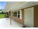 Covered porch with view of yard and windows with white shutters at 4708 Bugg Rd, Plant City, FL 33567