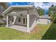 Close up of a covered back patio with a ceiling fan and supporting columns, offering a shaded retreat at 4717 W Anita Blvd, Tampa, FL 33611