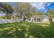 A spacious backyard with lush lawn and privacy fence provides ample space for outdoor activities and relaxation at 4717 W Anita Blvd, Tampa, FL 33611