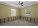 Bedroom with two windows, ceiling fan, and yellow walls, ready for renovation at 4717 W Anita Blvd, Tampa, FL 33611