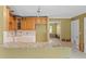 Kitchen featuring granite countertops, wooden cabinetry and stainless steel appliances at 4717 W Anita Blvd, Tampa, FL 33611