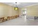 Bright room with white tile floors, a unique green bottle chandelier, and visible wall framing at 4717 W Anita Blvd, Tampa, FL 33611