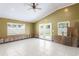 Spacious room with white tile floors, french doors and visible wall framing at 4717 W Anita Blvd, Tampa, FL 33611