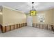 Bright room with white tile floors, a unique green bottle chandelier, and visible wall framing at 4717 W Anita Blvd, Tampa, FL 33611