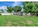 Spacious backyard featuring a screened-in porch, lush greenery, and a tranquil ambiance for relaxation and entertainment at 517 Fairhope Dr, Apollo Beach, FL 33572