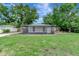 The property features a screened-in back porch, complemented by a vast, well-manicured lawn perfect for outdoor activities at 517 Fairhope Dr, Apollo Beach, FL 33572