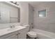 Bathroom featuring a white vanity, a toilet, and a tiled shower-over-tub combo at 517 Fairhope Dr, Apollo Beach, FL 33572
