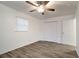 Cozy bedroom featuring wood-look floors, a ceiling fan, a window, and a double-door closet at 517 Fairhope Dr, Apollo Beach, FL 33572