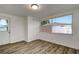 Bright bedroom featuring updated flooring, large windows, closet and door to exterior at 517 Fairhope Dr, Apollo Beach, FL 33572