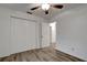 Bedroom featuring wood-look floors, a ceiling fan, and a double-door closet at 517 Fairhope Dr, Apollo Beach, FL 33572