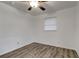 Bedroom featuring wood-look floors, a ceiling fan, and a bright window at 517 Fairhope Dr, Apollo Beach, FL 33572