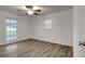 Bedroom features updated flooring, exterior access, and ceiling fan at 517 Fairhope Dr, Apollo Beach, FL 33572