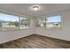Bright bedroom featuring updated flooring and large windows for plenty of natural light at 517 Fairhope Dr, Apollo Beach, FL 33572