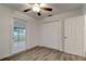 Bedroom featuring wood-look floors, a ceiling fan, a closet, and a glass door to the outdoors at 517 Fairhope Dr, Apollo Beach, FL 33572