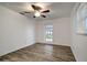 Bright bedroom with wood-look floors, a ceiling fan, and a glass door to the outside at 517 Fairhope Dr, Apollo Beach, FL 33572