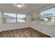 Bright bedroom featuring updated flooring and two large windows for plenty of natural light at 517 Fairhope Dr, Apollo Beach, FL 33572