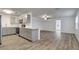 Open kitchen with gray cabinets, stainless steel appliances, quartz countertops and vinyl floors at 517 Fairhope Dr, Apollo Beach, FL 33572