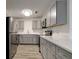Updated kitchen features gray cabinets, stainless steel appliances, and quartz countertops at 517 Fairhope Dr, Apollo Beach, FL 33572