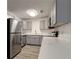 Updated kitchen features gray cabinets, stainless steel appliances, and quartz countertops at 517 Fairhope Dr, Apollo Beach, FL 33572