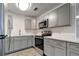 Updated kitchen features gray cabinets, stainless steel appliances, and quartz countertops at 517 Fairhope Dr, Apollo Beach, FL 33572