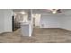 Open kitchen with gray cabinets, stainless steel appliances, quartz countertops and vinyl floors at 517 Fairhope Dr, Apollo Beach, FL 33572