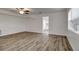 Bright room with wood-look floors, a ceiling fan, and natural light, perfect for relaxation and comfort at 517 Fairhope Dr, Apollo Beach, FL 33572