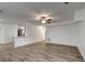 Bright living room featuring wood-look floors and an open concept with eat in kitchen at 517 Fairhope Dr, Apollo Beach, FL 33572