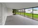 An empty screened-in porch, offering an outdoor space while remaining protected from insects and the elements at 517 Fairhope Dr, Apollo Beach, FL 33572