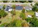 Aerial view of property featuring a lawn and delineated property line surrounded by lush trees at 5352 Lowell Ave, Spring Hill, FL 34609