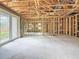 Open basement area featuring concrete walls and floors, and French doors leading to the exterior at 5352 Lowell Ave, Spring Hill, FL 34609