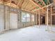 Unfinished basement with concrete walls, door to the outside, and an exposed beam ceiling at 5352 Lowell Ave, Spring Hill, FL 34609