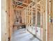 Exposed wood studs and wiring throughout the unfinished basement area; box of flooring on the floor at 5352 Lowell Ave, Spring Hill, FL 34609