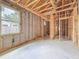 Unfinished basement, with exposed wood frame construction, block walls and bright window at 5352 Lowell Ave, Spring Hill, FL 34609