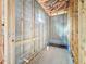Partially tiled unfinished bathroom featuring wood framing, concrete block walls, and rough plumbing at 5352 Lowell Ave, Spring Hill, FL 34609