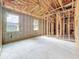 Spacious unfinished bedroom featuring wood framing, concrete block walls, and multiple windows at 5352 Lowell Ave, Spring Hill, FL 34609