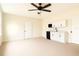 Bonus room with a kitchenette, white cabinets, sink, microwave and mini fridge at 5352 Lowell Ave, Spring Hill, FL 34609