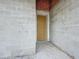 A raw block wall entrance with a front door inside a home under construction at 5352 Lowell Ave, Spring Hill, FL 34609